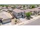 Charming two-story house featuring a tile roof, a basketball hoop, and an inviting arched entryway at 16917 W Sonora St, Goodyear, AZ 85338