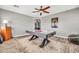 This game room has a sleek air hockey table set on a patterned rug with wood-look flooring at 16917 W Sonora St, Goodyear, AZ 85338
