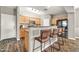 This kitchen features wood cabinets, stainless steel appliances, and three bar stools at the countertop at 16917 W Sonora St, Goodyear, AZ 85338