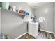 Well-lit laundry room with appliances and shelving for ample storage at 16917 W Sonora St, Goodyear, AZ 85338