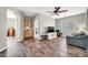 Spacious living room showcasing seamless transitions, modern decor, and sleek wood flooring at 16917 W Sonora St, Goodyear, AZ 85338