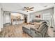 Open-concept living room showcasing wood-look floors, neutral paint, comfortable seating, and a breakfast bar at 16917 W Sonora St, Goodyear, AZ 85338