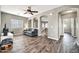 Open living space with archways, a comfortable sofa, and neutral-toned decor with wood-look floors at 16917 W Sonora St, Goodyear, AZ 85338