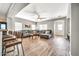 Open-concept living room features wood-look floors, neutral paint, comfortable seating, and ample natural light at 16917 W Sonora St, Goodyear, AZ 85338