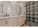 Bright bathroom with double vanity, neutral walls, quartz countertops and decorative shower tiles at 1718 W Colter St # 142, Phoenix, AZ 85015