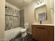 Bathroom featuring a bathtub with tile surround, modern fixtures and vanity with a wood finish at 1718 W Colter St # 142, Phoenix, AZ 85015