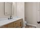 Half bathroom with a wood vanity, quartz countertop and modern black fixtures at 1718 W Colter St # 142, Phoenix, AZ 85015