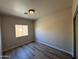 Cozy bedroom with wood-look tile flooring and a view of the exterior at 1718 W Colter St # 142, Phoenix, AZ 85015