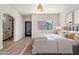 Bedroom featuring neutral walls, wood-look floors, and a window for plenty of natural light at 1718 W Colter St # 142, Phoenix, AZ 85015