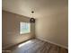 Comfortable bedroom with natural light, neutral walls, and wood-look tile flooring at 1718 W Colter St # 142, Phoenix, AZ 85015