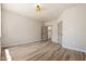 Empty bedroom with wood-look floors, natural light and two doors at 1718 W Colter St # 142, Phoenix, AZ 85015