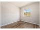 Bright bedroom features wood-look flooring and a large window at 1718 W Colter St # 142, Phoenix, AZ 85015