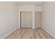 Bedroom with wood-look floors, neutral walls and closet doors at 1718 W Colter St # 142, Phoenix, AZ 85015