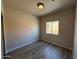 Neutral bedroom featuring wood-look floors, a window offering natural light, and a ceiling light at 1718 W Colter St # 142, Phoenix, AZ 85015
