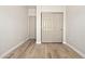 Bedroom featuring a closet with sliding doors and laminate floors at 1718 W Colter St # 142, Phoenix, AZ 85015