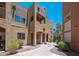 Beautiful building exterior with desert landscaping, stucco walls, arched entryways, and outdoor balconies at 1718 W Colter St # 142, Phoenix, AZ 85015