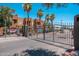 Gated entrance to the community, with desert landscaping and palm trees at 1718 W Colter St # 142, Phoenix, AZ 85015