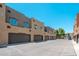 Exterior street view of condos with garages along a street at 1718 W Colter St # 142, Phoenix, AZ 85015
