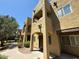 Exterior view of a multi-story condo building featuring private balconies and desert landscaping at 1718 W Colter St # 142, Phoenix, AZ 85015