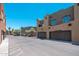 Exterior street view of condos with garages along a street at 1718 W Colter St # 142, Phoenix, AZ 85015