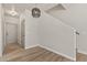 Hallway featuring a staircase, wood floors, neutral paint, and doors leading to other rooms in the home at 1718 W Colter St # 142, Phoenix, AZ 85015