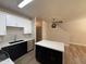 Modern kitchen featuring sleek black and white cabinetry, an island, and stainless steel appliances at 1718 W Colter St # 142, Phoenix, AZ 85015