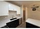 Well-lit kitchen featuring an island, stainless steel appliances, and a modern backsplash at 1718 W Colter St # 142, Phoenix, AZ 85015