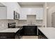 Close-up of kitchen featuring white cabinets, stainless steel appliances, gray backsplash, and wood flooring at 1718 W Colter St # 142, Phoenix, AZ 85015