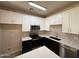Bright kitchen showcasing white cabinets, a stainless steel microwave, and a stylish backsplash at 1718 W Colter St # 142, Phoenix, AZ 85015