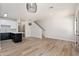 Bright living room with wood floors, staircase, stylish lighting, and seamless transition to the kitchen area at 1718 W Colter St # 142, Phoenix, AZ 85015