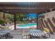View of community pool from shaded seating area and pergola at 1718 W Colter St # 142, Phoenix, AZ 85015