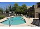 Community pool and grilling area surrounded by lush landscaping with lounge seating at 1718 W Colter St # 142, Phoenix, AZ 85015