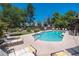 Inviting community pool with lounge chairs and mature landscaping at 1718 W Colter St # 142, Phoenix, AZ 85015