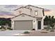 Beautiful two-story home featuring desert landscaping, two-car garage, and a covered entry at 17379 W Jessie Ln, Surprise, AZ 85387