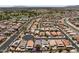 Aerial view of a single-Gathering home with a blue outline, situated in a well-planned community with a golf course at 18066 W Weatherby Dr, Surprise, AZ 85374