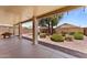 Covered patio in backyard with ample seating, desert landscaping and block wall fencing at 18066 W Weatherby Dr, Surprise, AZ 85374