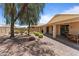 Spacious backyard with covered patio, rock landscaping, mature trees, and block fencing at 18066 W Weatherby Dr, Surprise, AZ 85374
