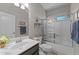 Well-maintained bathroom featuring a single sink vanity, glass shower, and tiled floor at 18066 W Weatherby Dr, Surprise, AZ 85374