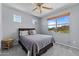 Cozy bedroom with carpet flooring, ceiling fan, and a window providing natural light at 18066 W Weatherby Dr, Surprise, AZ 85374