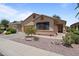 Charming single-story home featuring desert landscaping, tile roof, and inviting front entrance at 18066 W Weatherby Dr, Surprise, AZ 85374