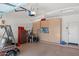 Organized garage with storage cabinets, pegboard, tool chest and golf cart at 18066 W Weatherby Dr, Surprise, AZ 85374