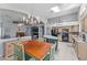 Open-concept kitchen features an island, granite countertops, modern appliances, and a dining area with chandelier at 18066 W Weatherby Dr, Surprise, AZ 85374