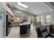 Modern kitchen featuring stainless steel appliances, a central island, and an adjacent dining area with natural light at 18066 W Weatherby Dr, Surprise, AZ 85374