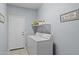 Laundry room featuring a white washer and dryer set, white door, and light blue-grey walls at 18066 W Weatherby Dr, Surprise, AZ 85374