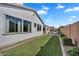 Backyard with green turf, stone patio, and ample space for outdoor activities and entertaining at 19428 S 210Th Pl, Queen Creek, AZ 85142