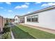 Landscaped backyard with green lawn, stone patio, and a cozy seating area at 19428 S 210Th Pl, Queen Creek, AZ 85142