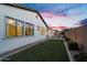 Exterior view of backyard with lush artificial turf and a charming outdoor seating area at 19428 S 210Th Pl, Queen Creek, AZ 85142