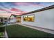 Well-manicured backyard features artificial turf, a covered patio, and lovely outdoor seating at 19428 S 210Th Pl, Queen Creek, AZ 85142