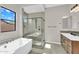 Well-lit bathroom featuring a glass-enclosed shower, tub, and wood vanity at 19428 S 210Th Pl, Queen Creek, AZ 85142