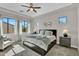 Bright and airy bedroom with large windows, neutral decor, and a ceiling fan at 19428 S 210Th Pl, Queen Creek, AZ 85142